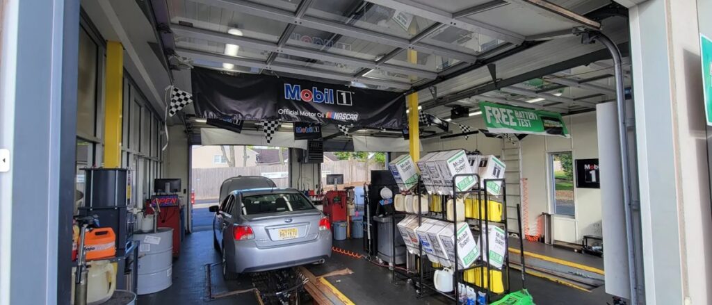 Mechanic changing a car's oil — a simple reminder of why regular oil changes matter